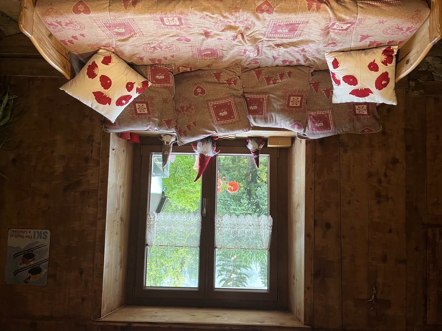 Cosy window seat with floral cushions in the Savoyard lounge
